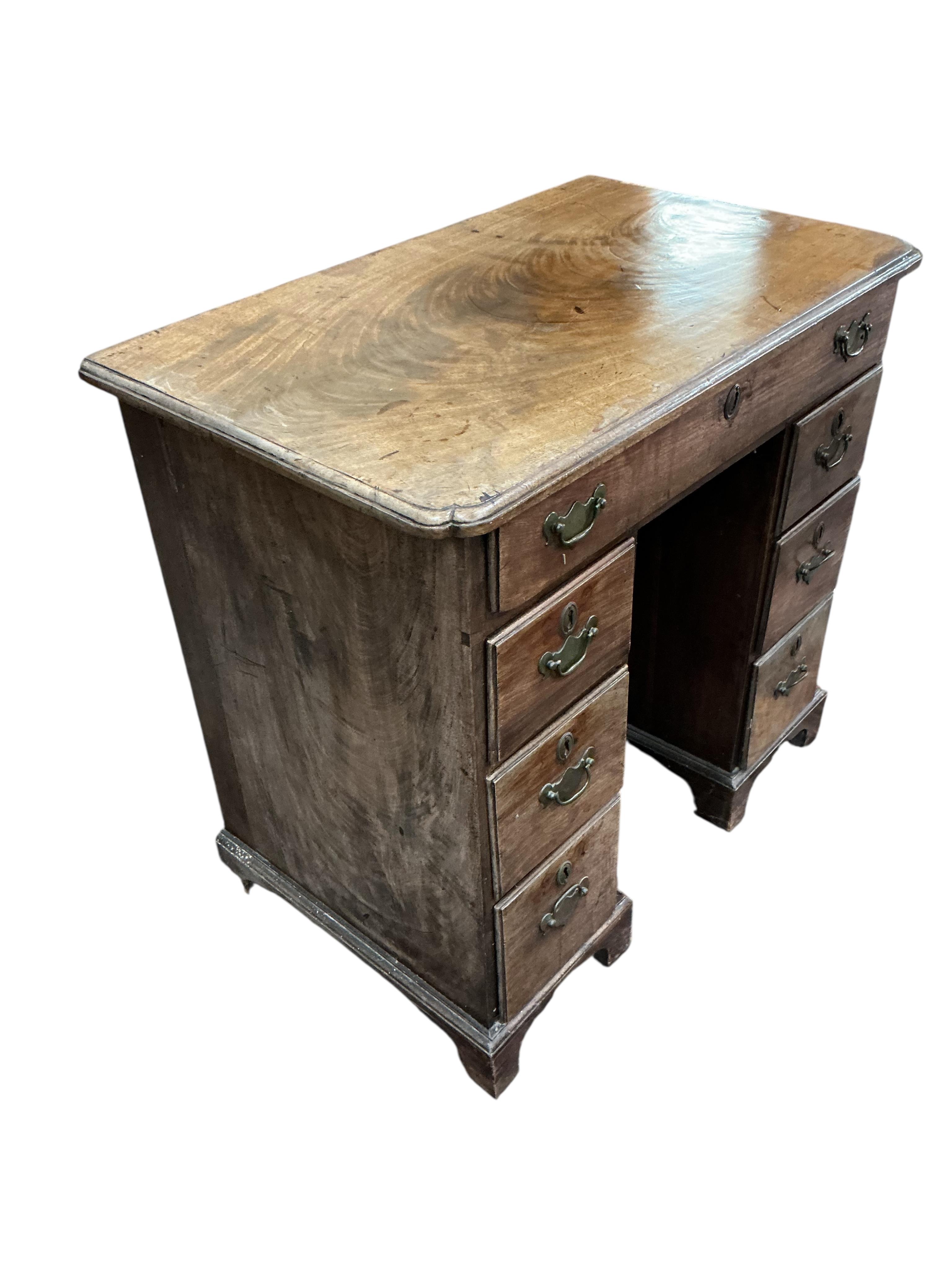 A George II mahogany kneehole desk, width 120cm, depth 48cm, height 75cm